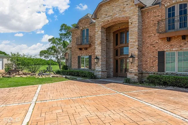 a view of a brick building next to a yard