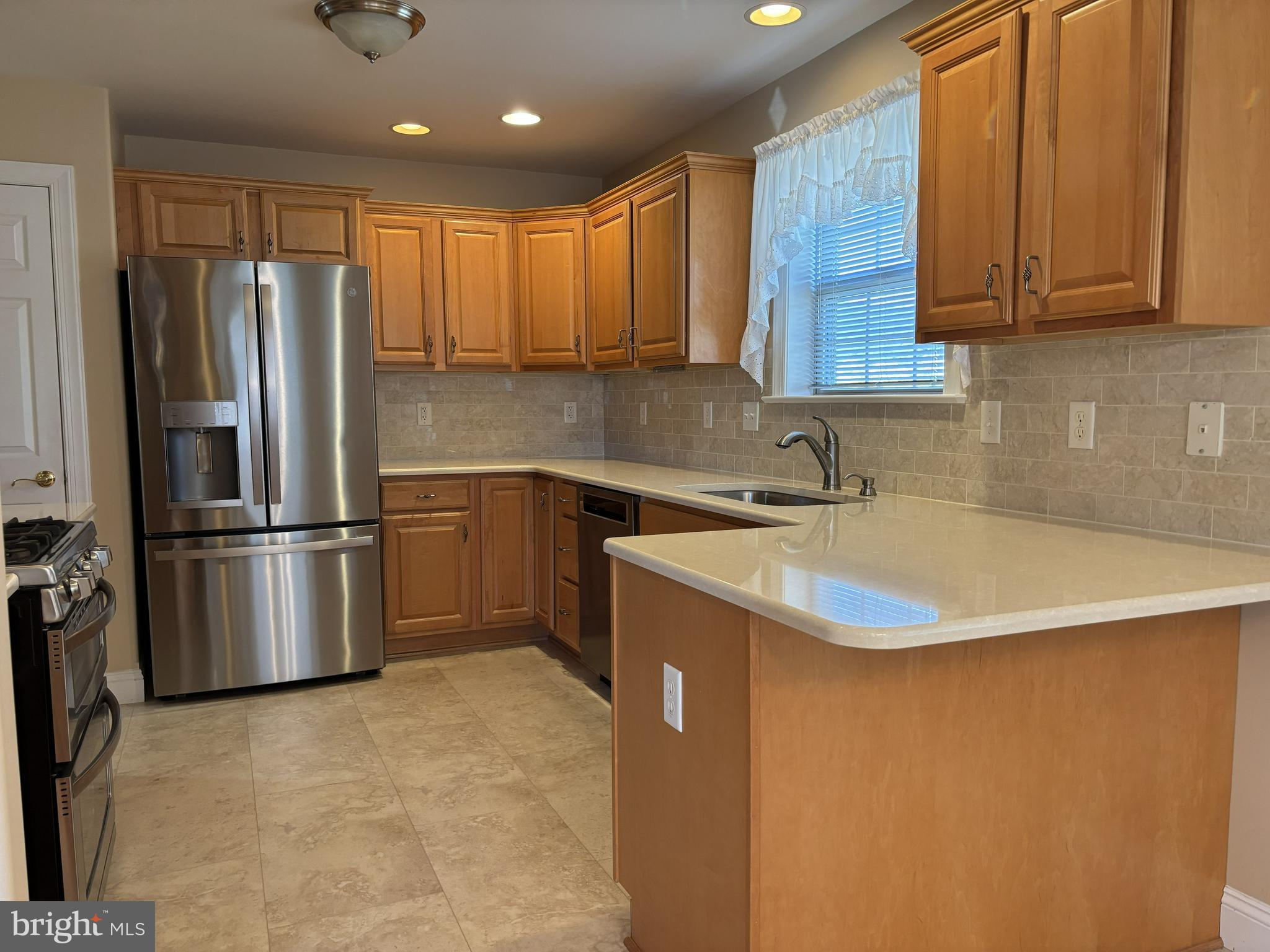 4300 North Victoria Way Harrisburg, PA 17112 - Photo 5 of 41 a kitchen with stainless steel appliances granite countertop a sink a stove a refrigerator a washer dryer and cabinets