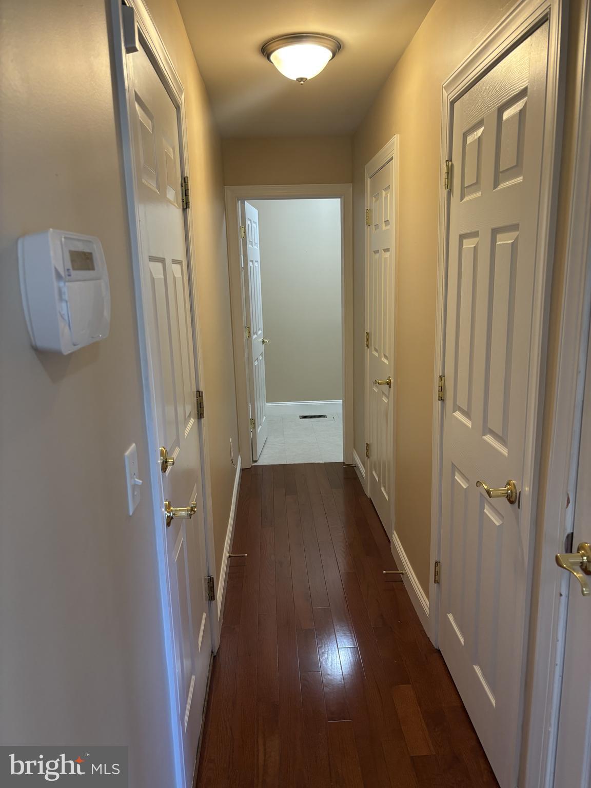 4300 North Victoria Way Harrisburg, PA 17112 - Photo 9 of 41 a view of a hallway with a wooden floor and a bathroom