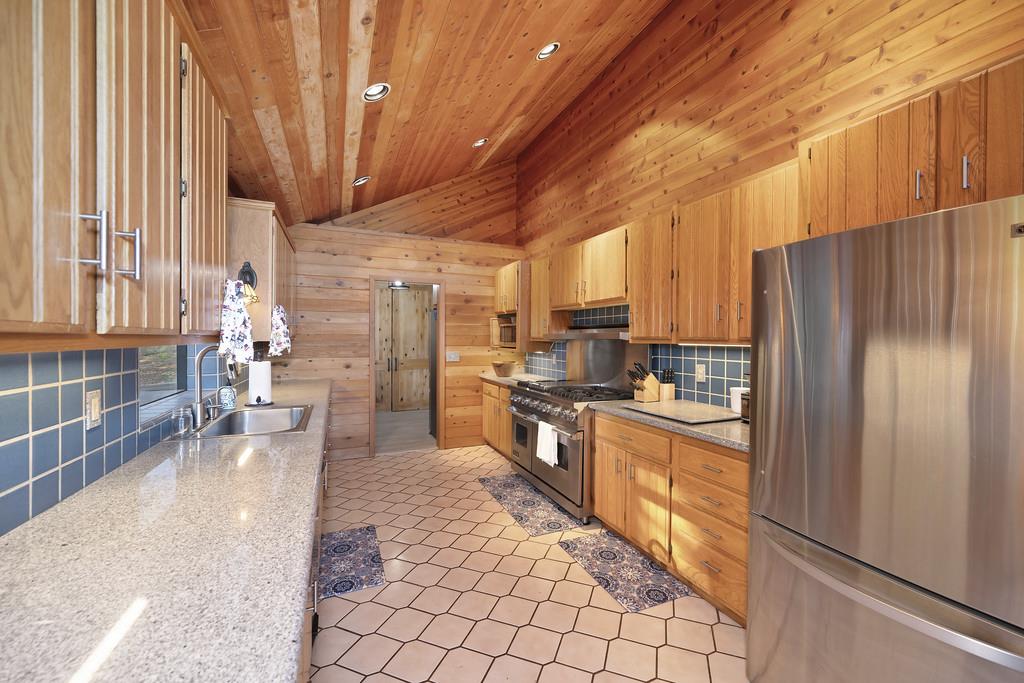 6301 Canyon Creek Road Georgetown, CA 95635 - Photo 19 of 87 a kitchen with stainless steel appliances a refrigerator and a stove