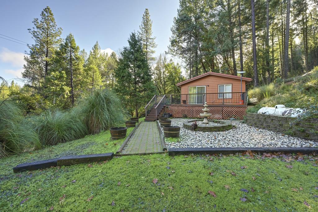 6301 Canyon Creek Road Georgetown, CA 95635 - Photo 64 of 87 a view of a wooden house with a yard and large trees