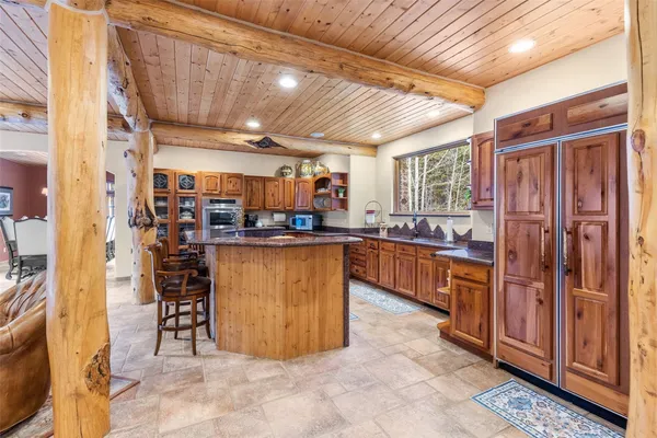 a kitchen with stainless steel appliances kitchen island granite countertop lots of counter top space