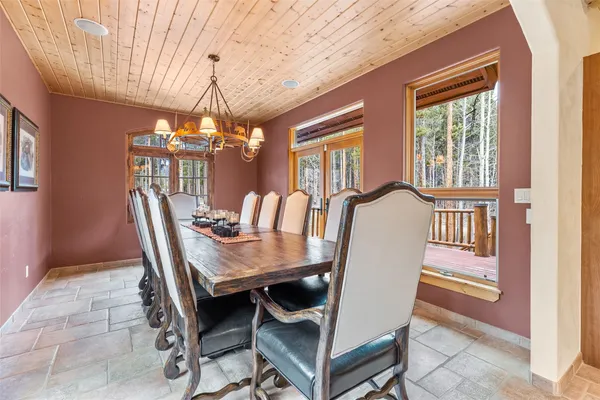 a dining room with furniture a chandelier and window
