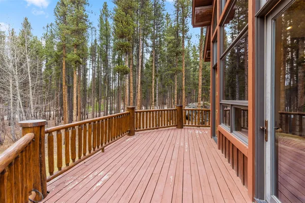 a view of a balcony with wooden floor and fence