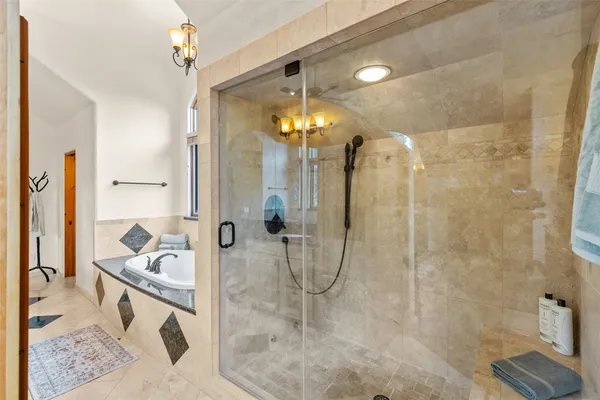 a bathroom with a sink a mirror and a shower