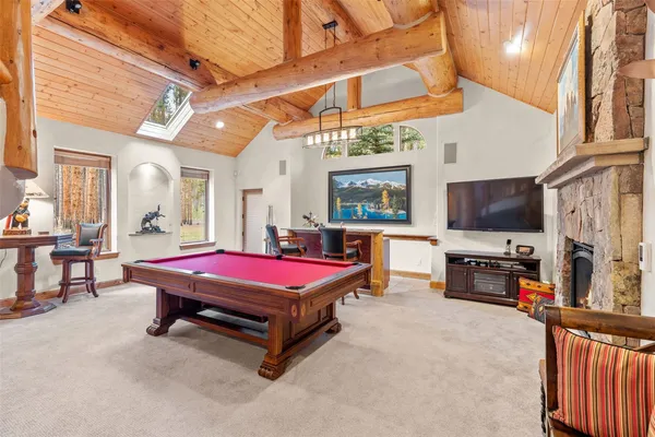 a pool table with chairs and rug