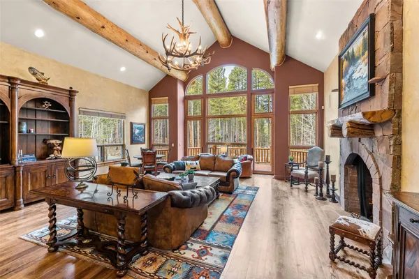 a living room with fireplace furniture and a large window
