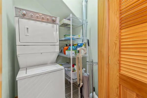 a kitchen with a dining table chairs and cabinets