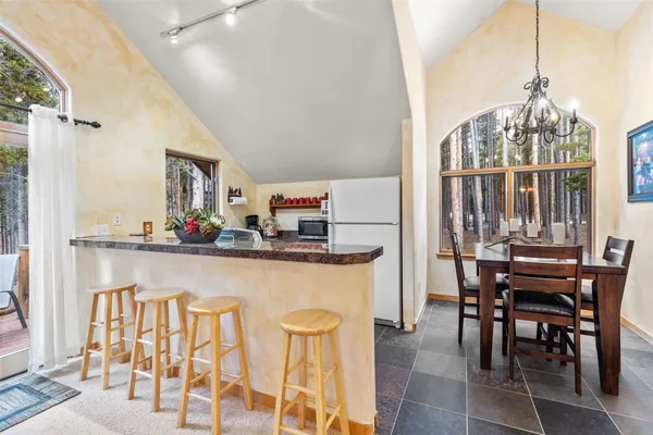 a kitchen with sink stove and view living room