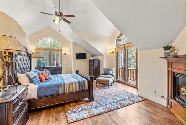 a living room with furniture fireplace and a large window