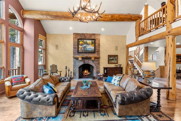 a living room with furniture a fireplace and a large window