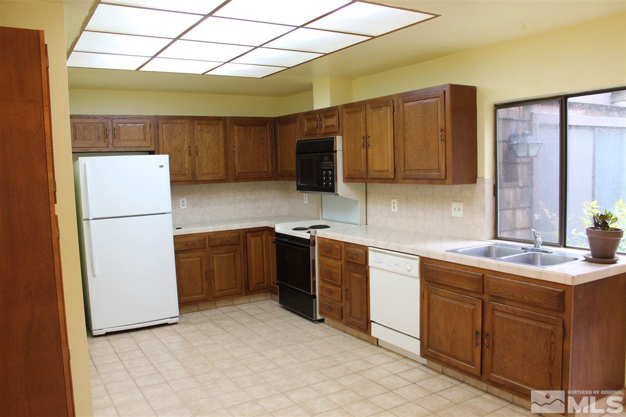 654 West Riverview Circle, Unit 654 Reno, NV 89509 - Photo 4 of 17 a kitchen with a sink a stove and refrigerator