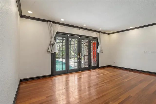 a view of a hallway with wooden floor and a fireplace