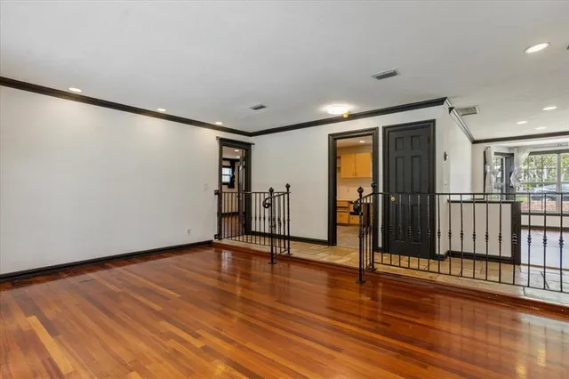 a view of a livingroom with wooden floor and a fireplace
