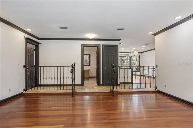 a view of a room with gym equipment and a large window