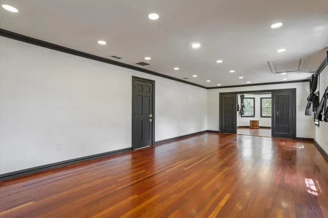 a view of room with window and wooden floor