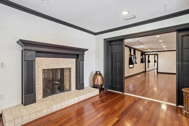 a large white kitchen with lots of counter space and chandelier