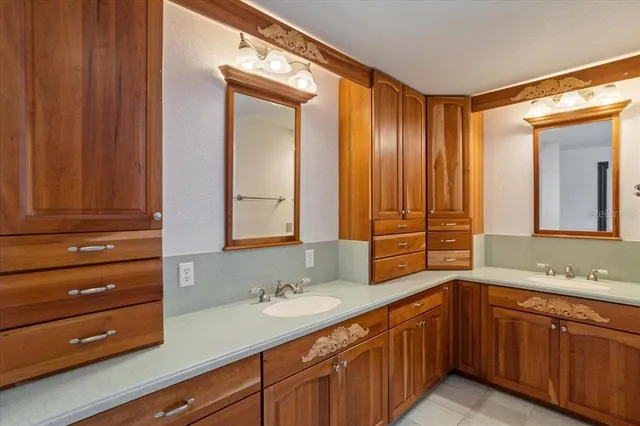 a view of an empty room with wooden floor and a ceiling fan