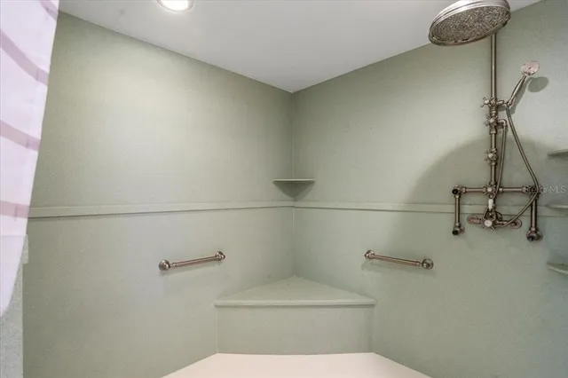 a bathroom with a granite countertop sink toilet a mirror and shower