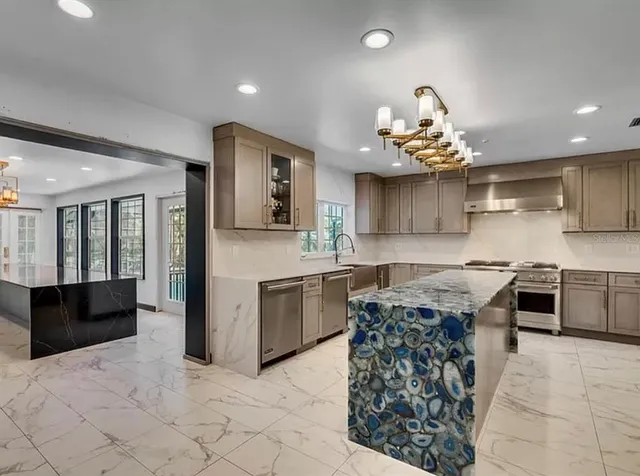 a kitchen with a stove a sink a microwave oven and a dining table