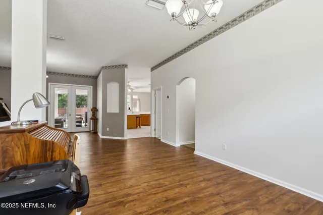a living room with furniture and a chandelier