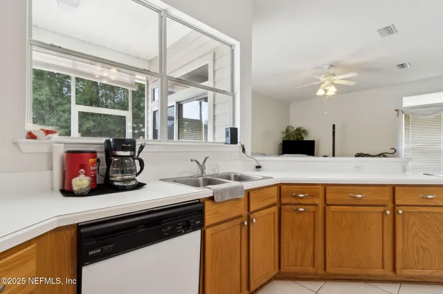 a kitchen with a sink cabinets and window