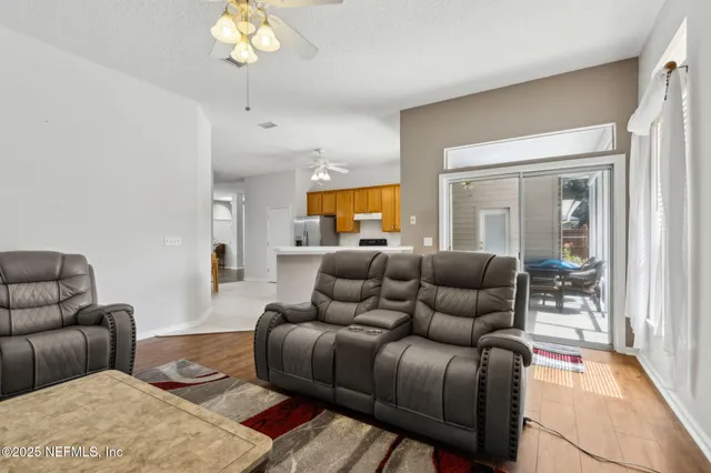 a living room with furniture and a chandelier