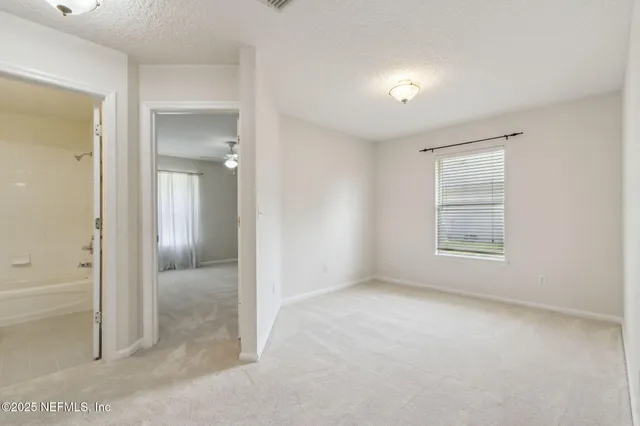 an empty room with windows and closet