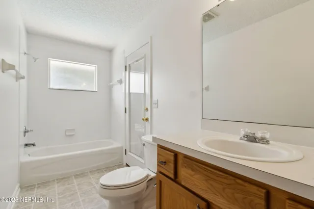 a bathroom with a toilet a sink and shower