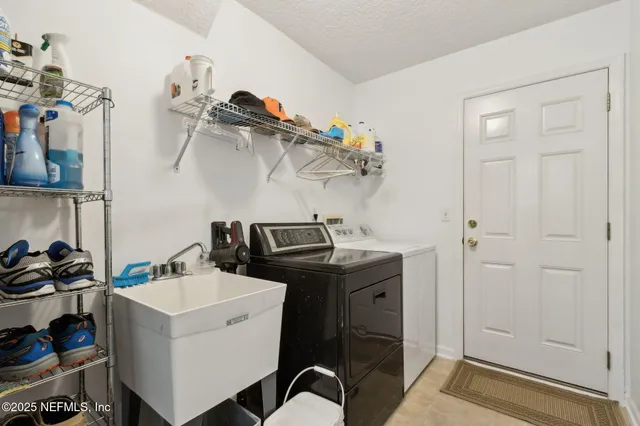 a living room with furniture a flat screen tv and a floor to ceiling window