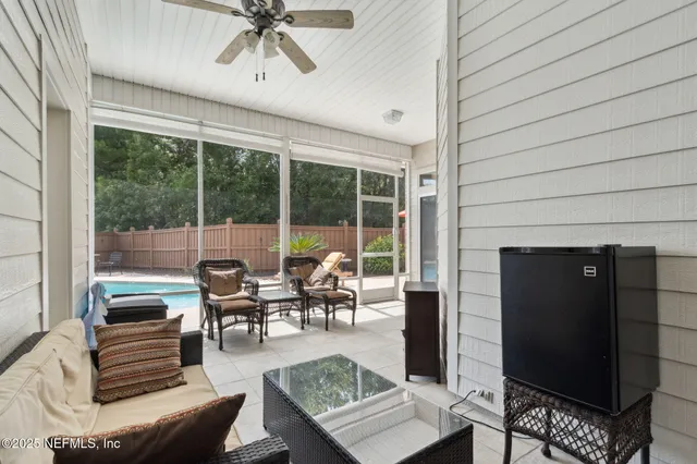 a patio with yard glass top table and chairs