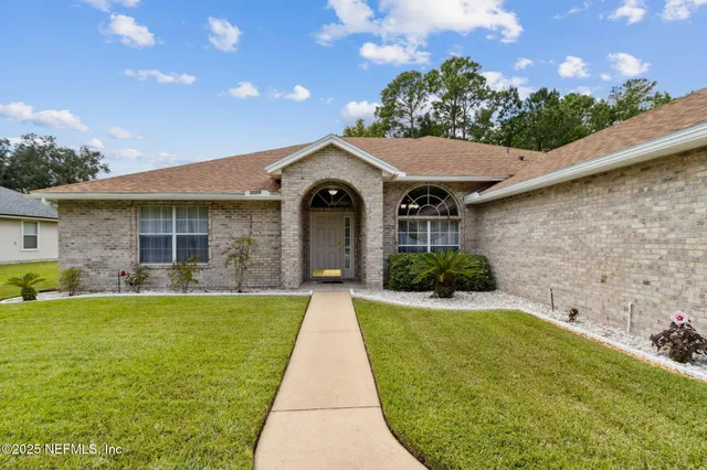 a front view of a house with a garden