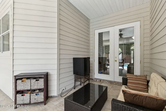 a dining room with furniture and a floor to ceiling window