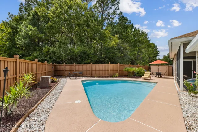 a swimming pool with outdoor seating and yard