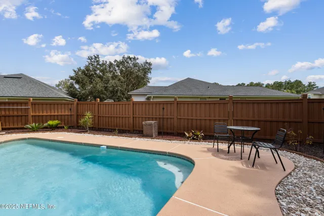 a view of a house with backyard sitting area and garden