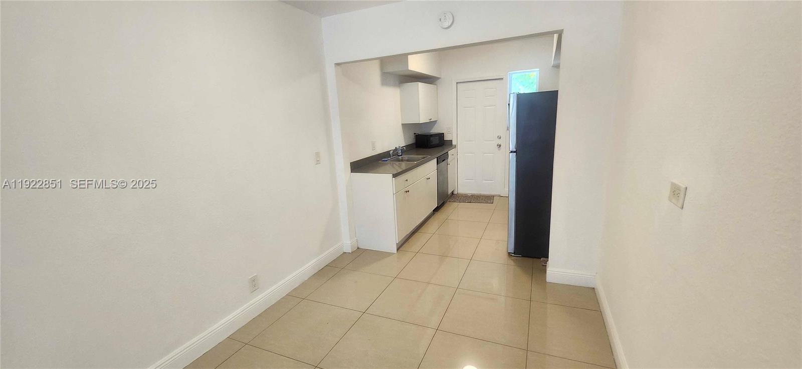 1050 98th Street, Unit 2W Bay Harbor Islands, FL 33154 - Photo 3 of 9 a bathroom with a sink and mirror