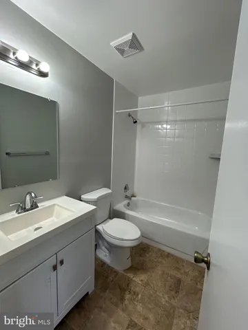 a bathroom with a double vanity sink toilet mirror and shower