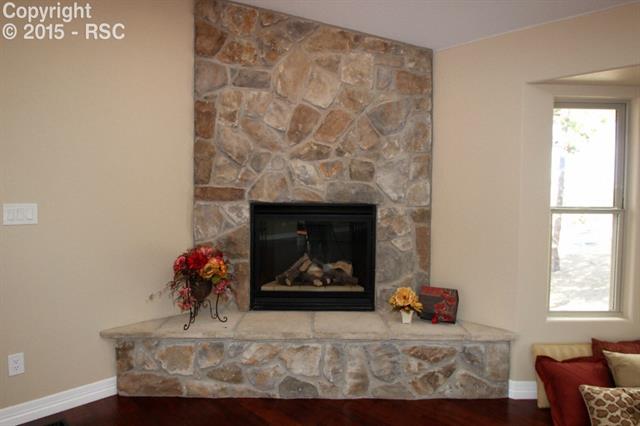 11420 Teachout Road Colorado Springs, CO 80908 - Photo 6 of 36 Gas fireplace in main level living room.