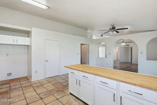 a spacious bathroom with a granite countertop sink and a mirror