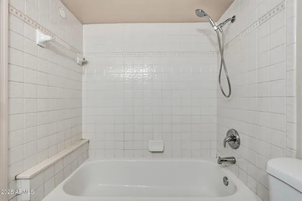 a bathroom with a bath tub with a shower