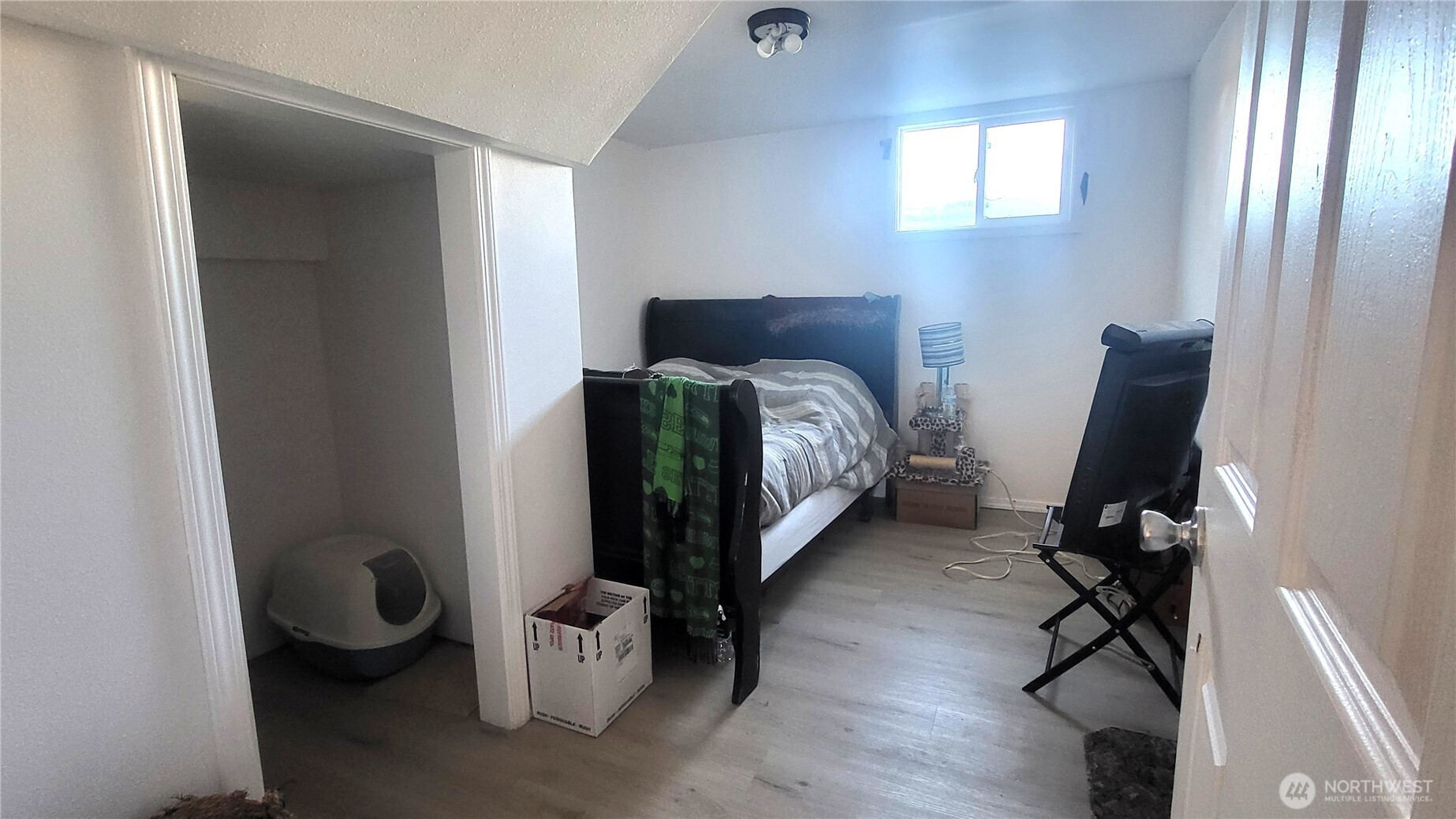 202 South 4th Street Odessa, WA 99159 - Photo 14 of 23 a bedroom with a bed and a chandelier