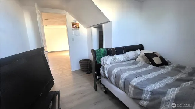 a bedroom with a bed and a window