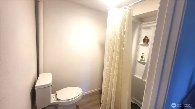 a white toilet sitting next to a bathroom sink