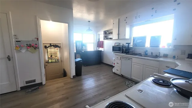 a kitchen with a refrigerator and a sink