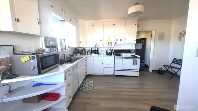 a kitchen with stainless steel appliances a sink a stove a refrigerator cabinets and a counter space