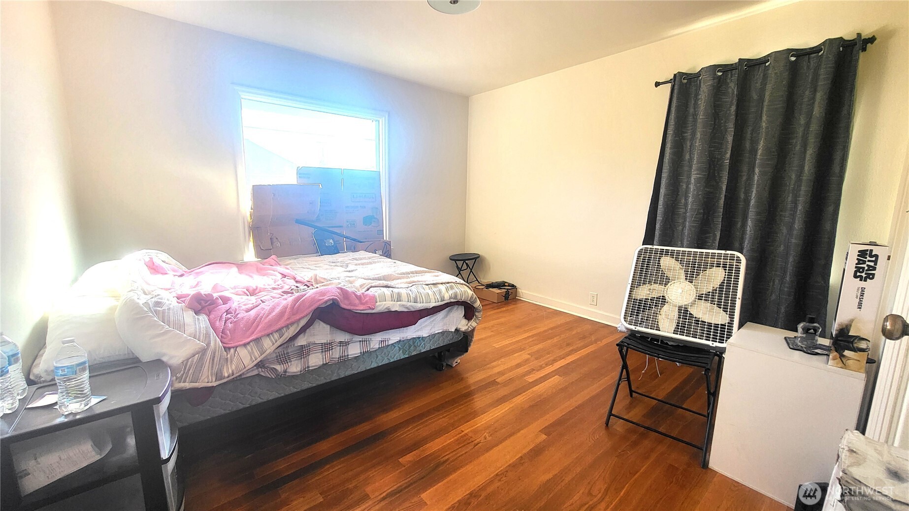 202 South 4th Street Odessa, WA 99159 - Photo 8 of 23 a bedroom with a bed and wooden floor