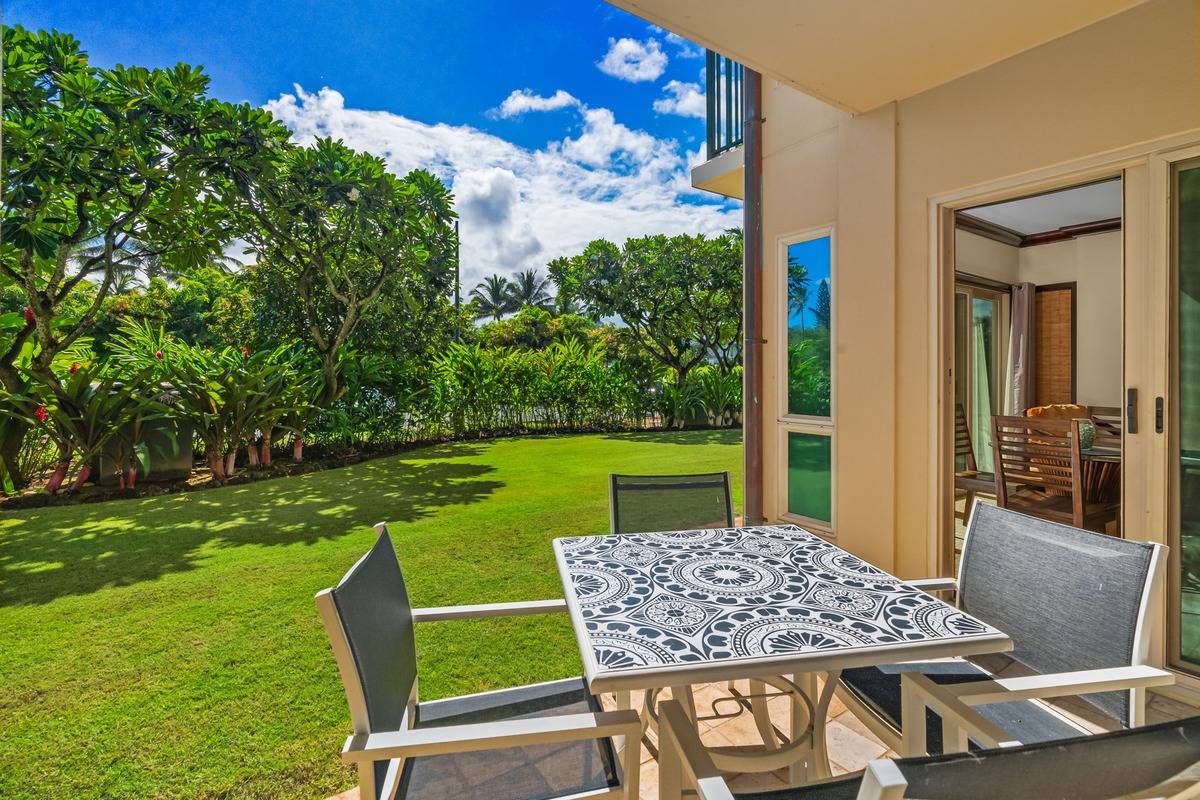 4-820 Kuhio Highway, Unit E103 Kapaa, HI 96746 - Photo 15 of 24 a view of an chairs and table in the garden