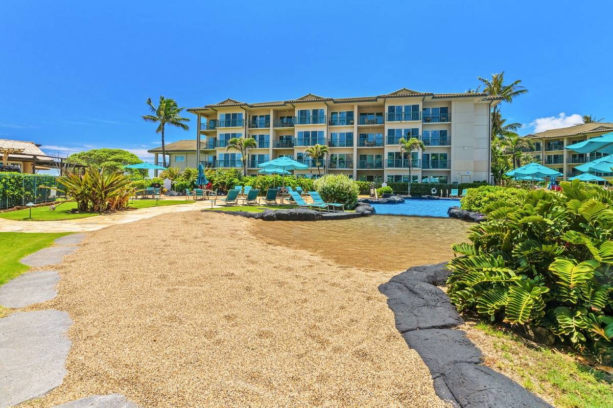 4-820 Kuhio Highway, Unit E103 Kapaa, HI 96746 - Photo 22 of 24 a front view of a house with a yard and potted plants