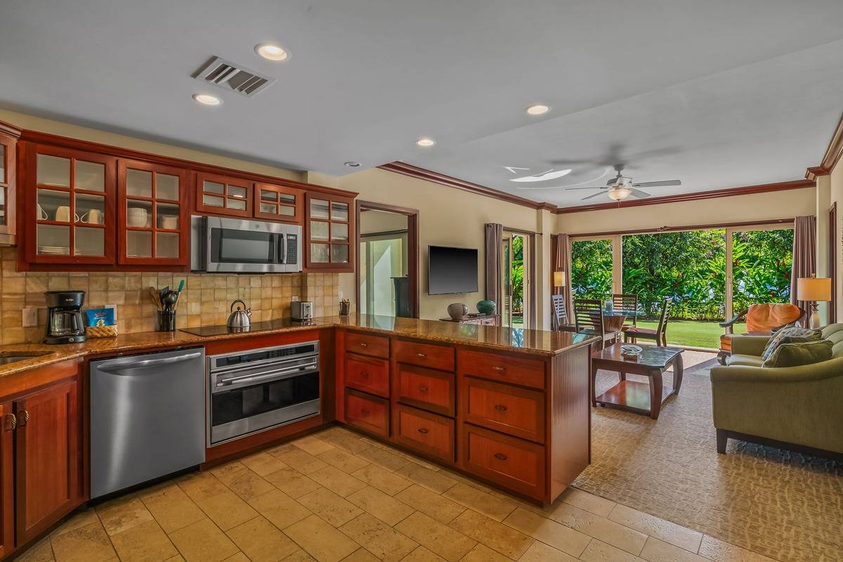 4-820 Kuhio Highway, Unit E103 Kapaa, HI 96746 - Photo 3 of 24 a kitchen with stainless steel appliances granite countertop a sink and cabinets