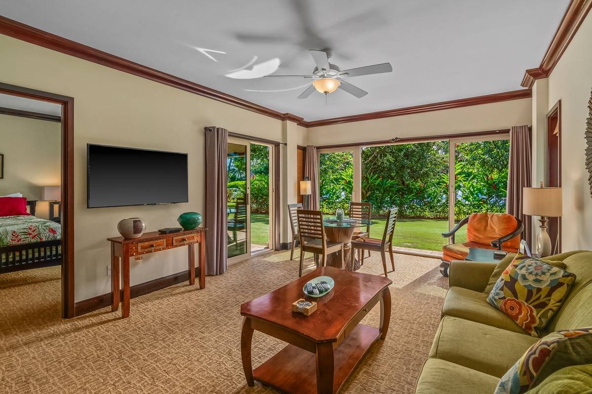4-820 Kuhio Highway, Unit E103 Kapaa, HI 96746 - Photo 4 of 24 a living room with furniture and a large window